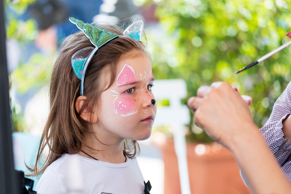 A view of a little girl with face paint on