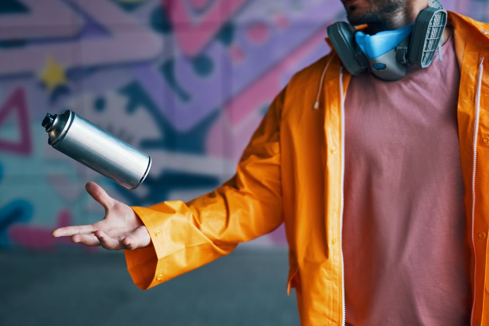 A view of a person holding a spray paint