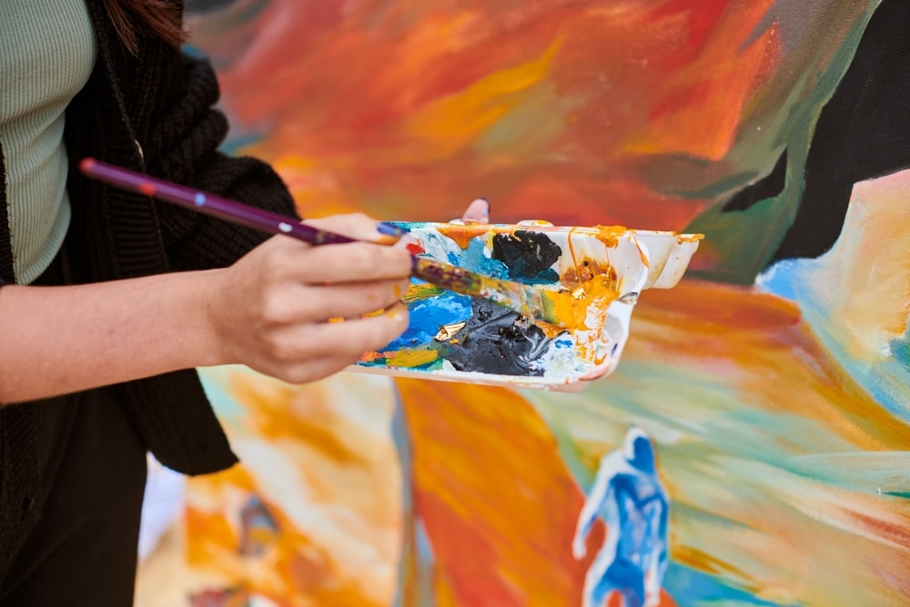 A view of a person mixing acrylic paints for painting