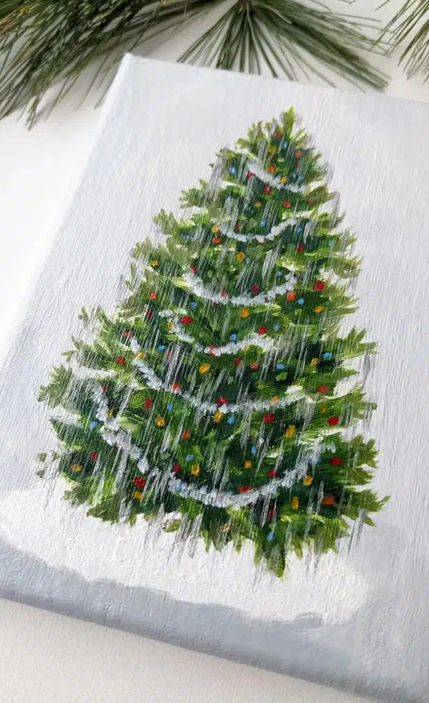 A christmas tree painted on a white canvas