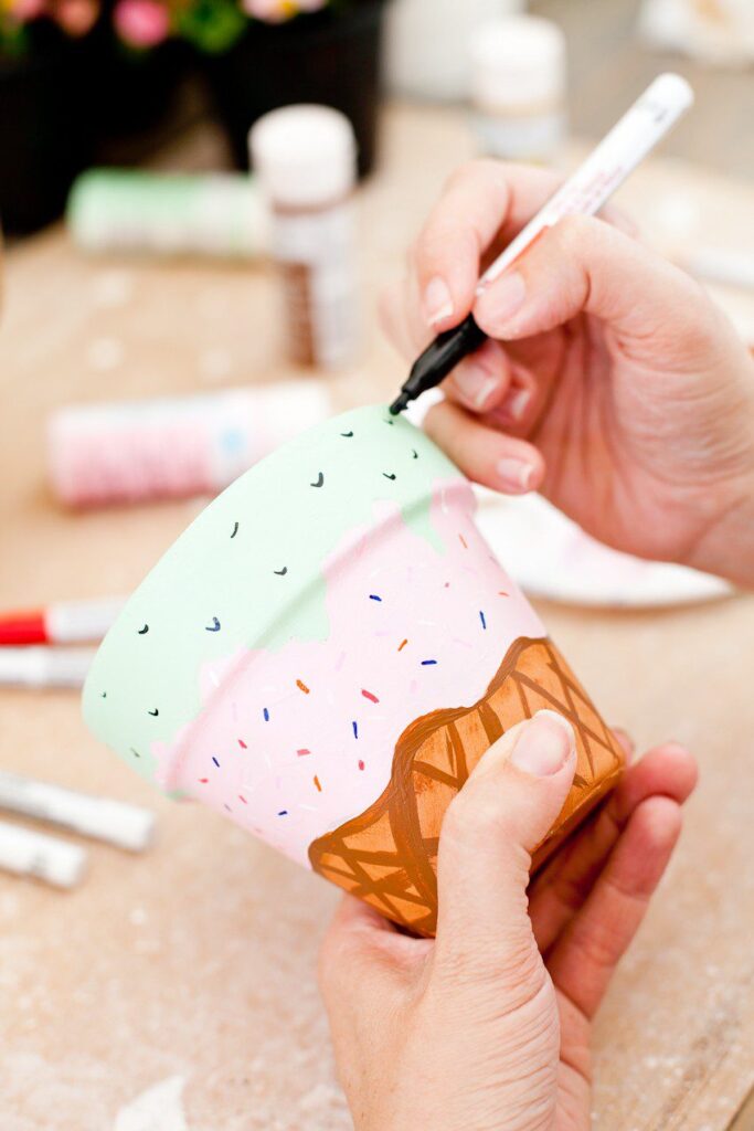 A hand drawing with a marker on ice cream cone painted flower pot