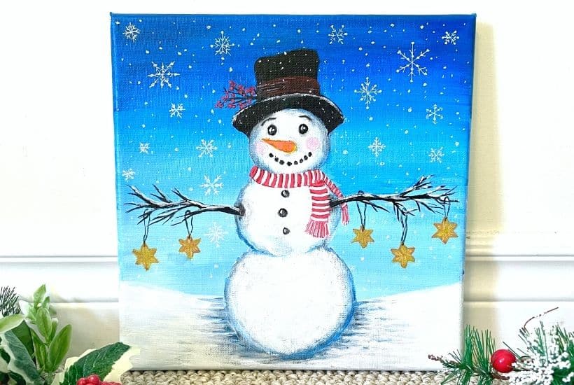 A snowman painted on a canvas