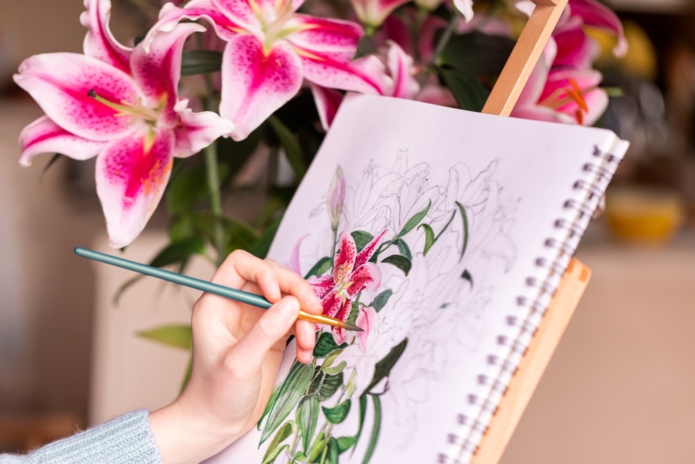 A view of a person painting flowers with watercolor