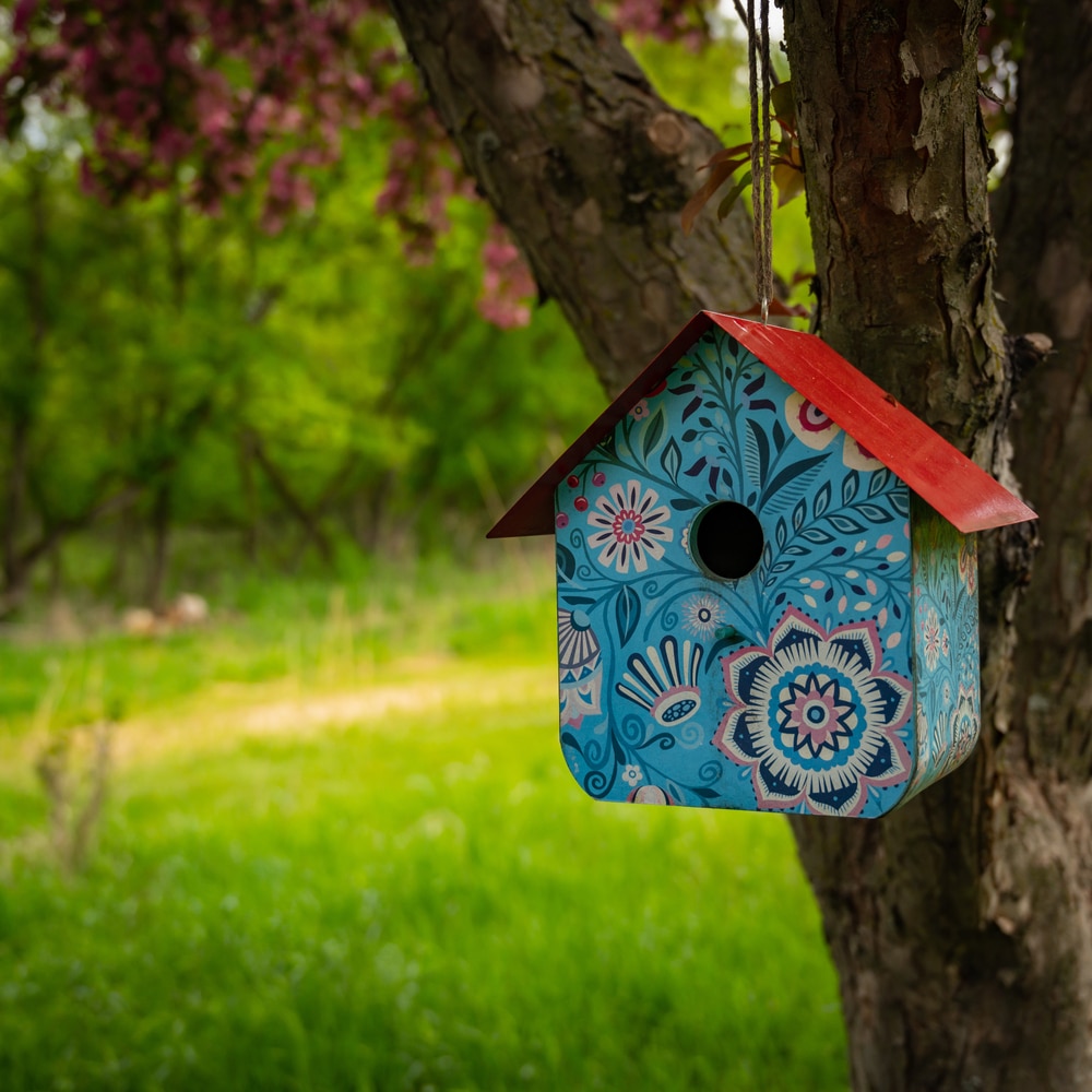 Birdhouse painted with petals and leaves