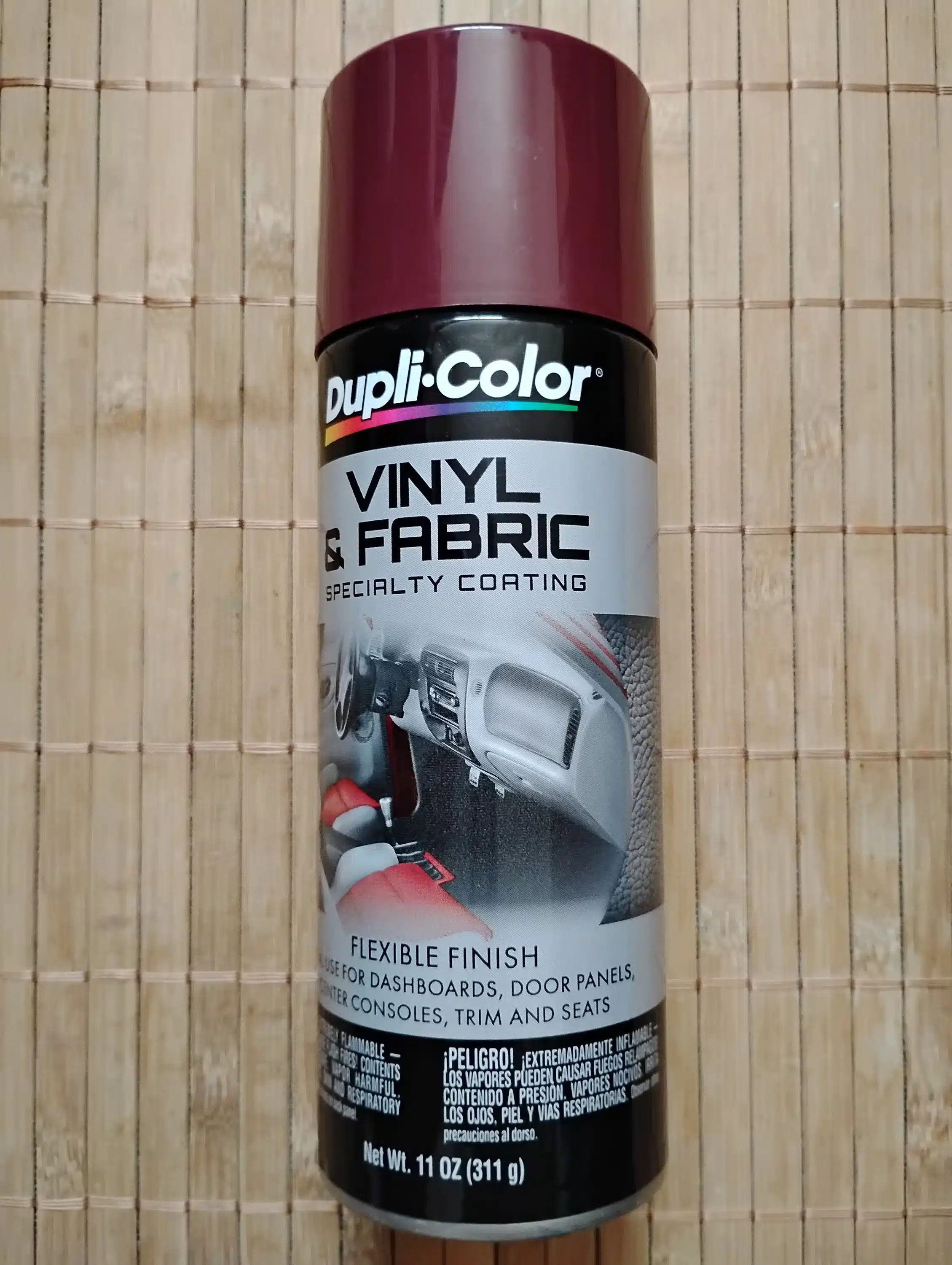 Dupli Color Vinyl and Fabric Spray placed on wooden surface Dupli Color Vinyl and Fabric Spray placed on wooden surface