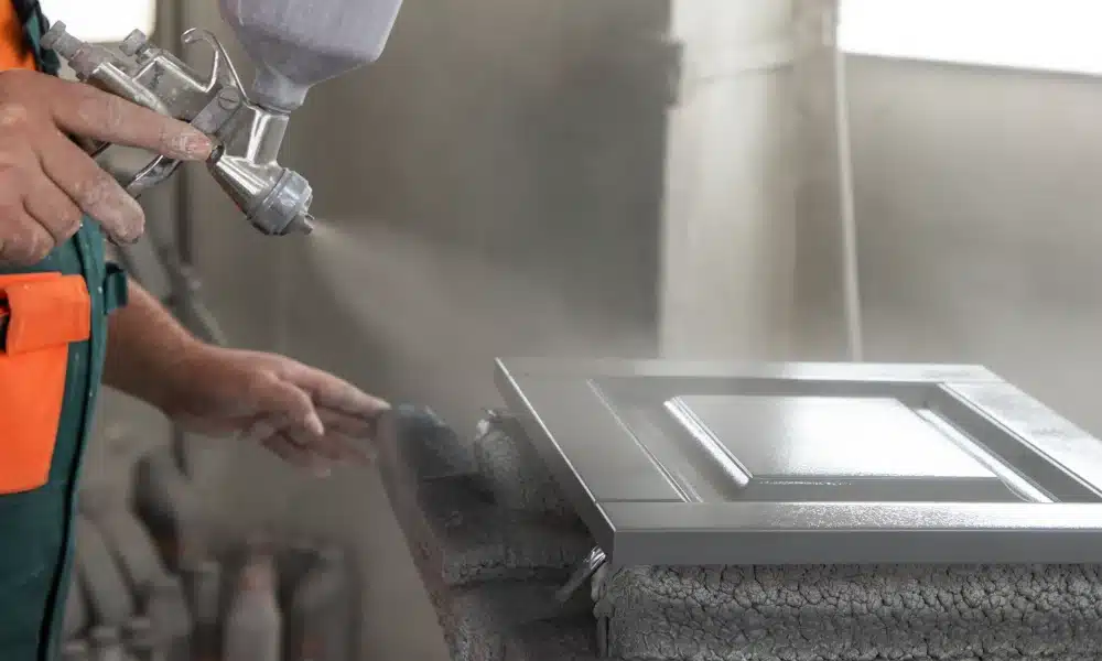 close up of a hand painting window shutters close up of a hand painting window shutters