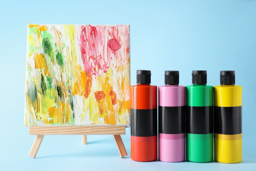 Acrylic Paints Of Different Colors And Small Easel With Abstract