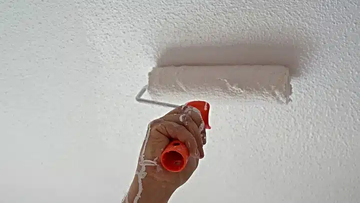 close up of a hand applying popcorn paint close up of a hand applying popcorn paint