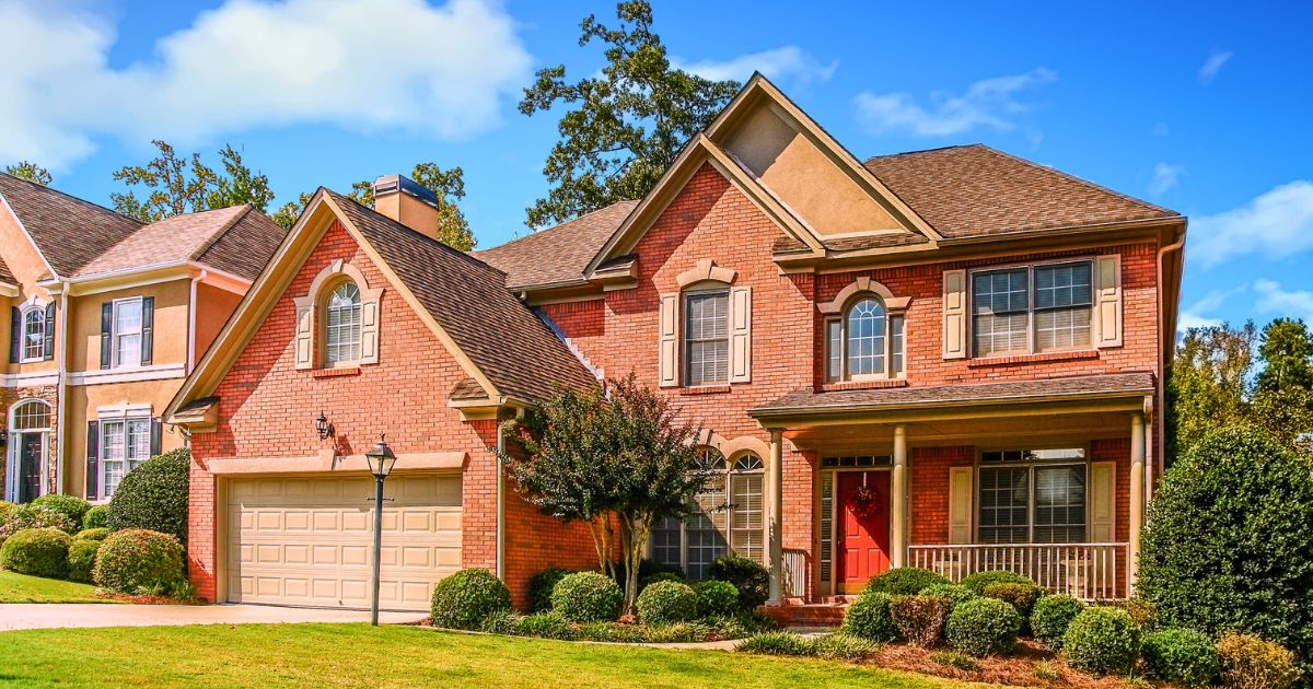 a red brick house isolated in a garden