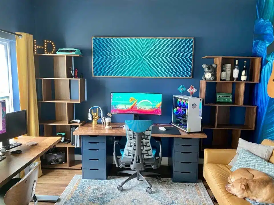 A stylish gaming room with a blue accent wall modern desk setup and colorful decor including a gaming PC and comfy seating