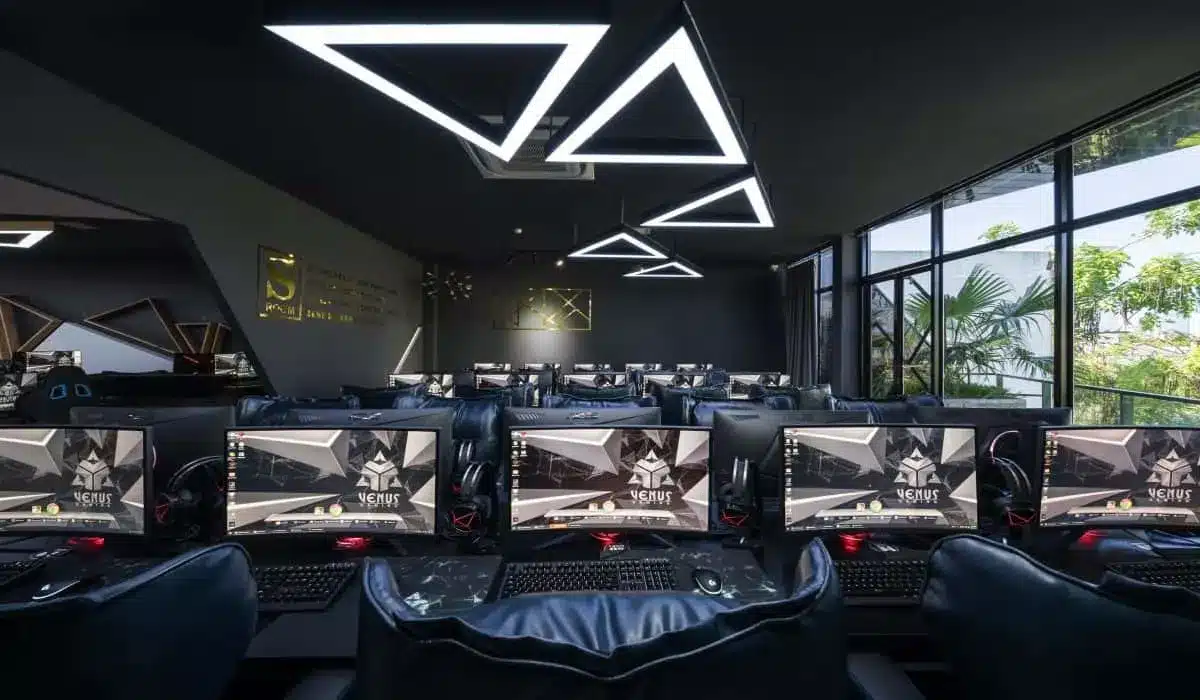 A modern gaming lounge with multiple high end gaming stations futuristic lighting and a sleek black interior design A modern gaming lounge with multiple high end gaming stations futuristic lighting and a sleek black interior design