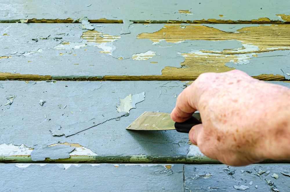 A view of a person scratching paint off A view of a person scratching paint off