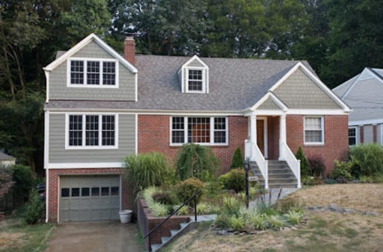 a beautiful red brick house with light gray roof