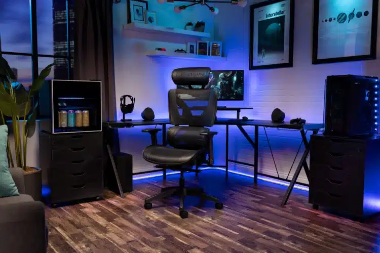 a gaming room with pc setup ergonomic chair and blue neon lights