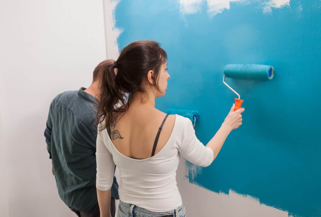 a girl repainting a wall a girl repainting a wall