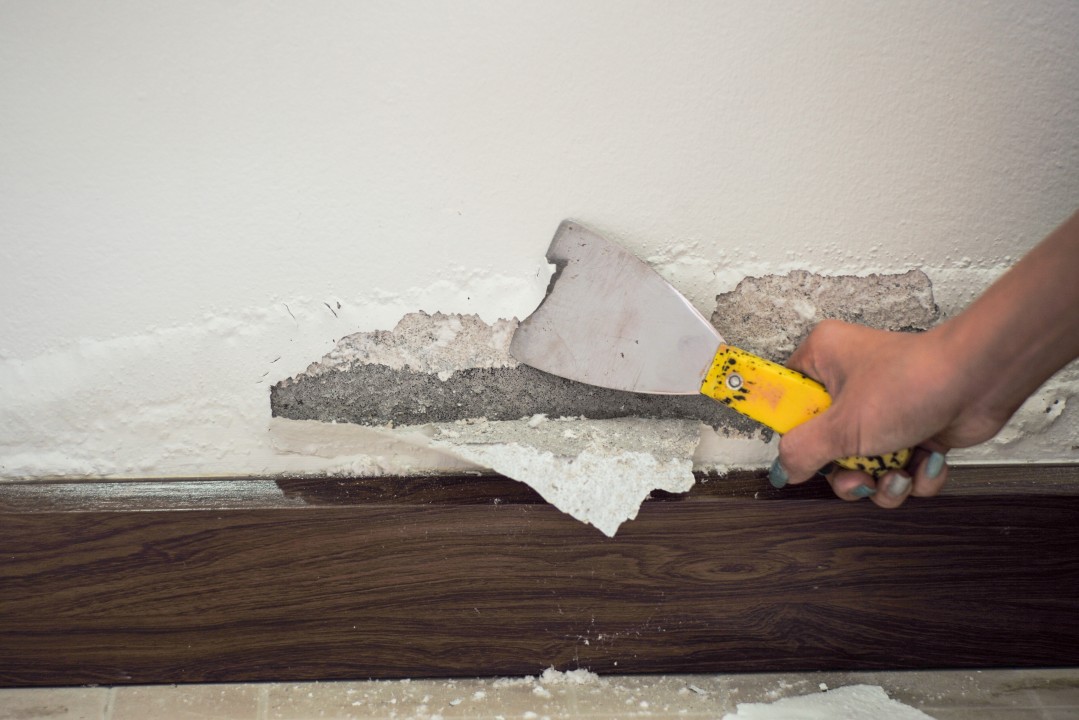 a person's hand working on bubbling paint