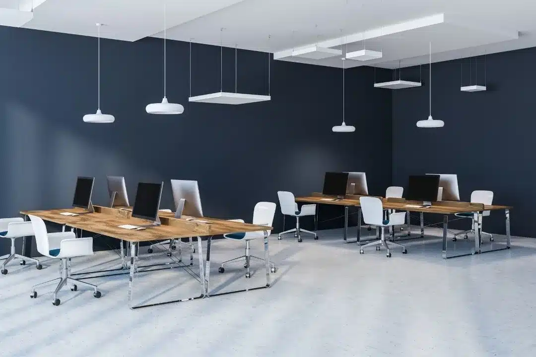 an office space with blue walls PC and chairs set up an office space with blue walls PC and chairs set up