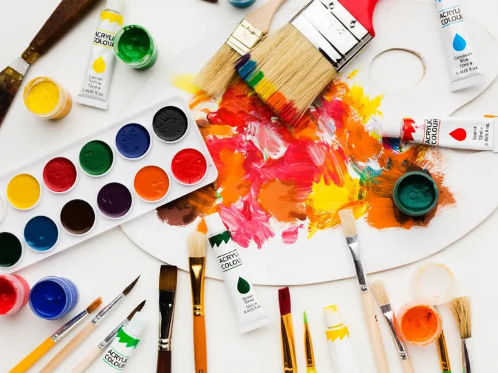 different paint colors and a painting board on a table