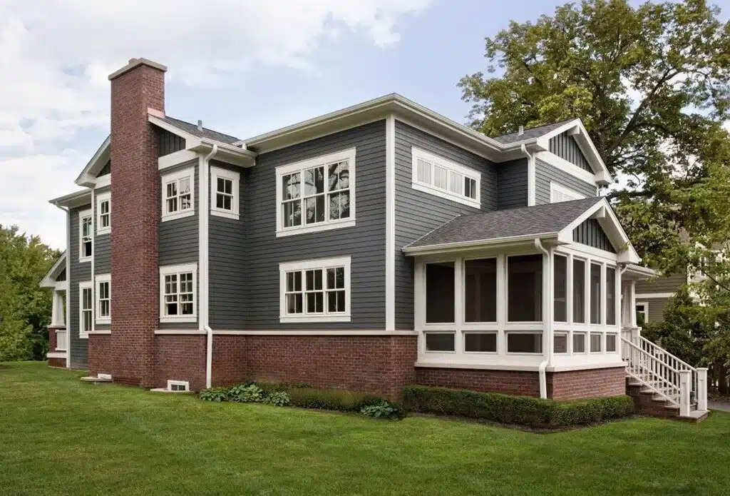 red brick house with gray roof and exterior walls