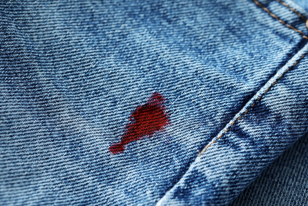 Stain Of Red Ink On Jeans Closeup Stain Of Red Ink On Jeans Closeup