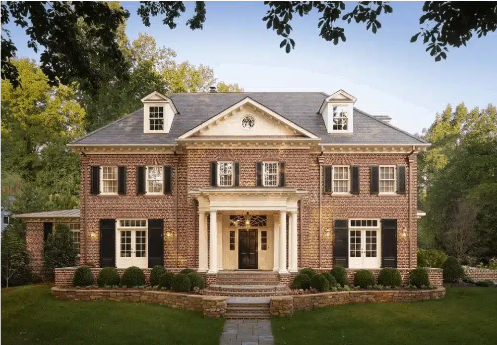 view of a beautiful antique house with red bricks and gray roof