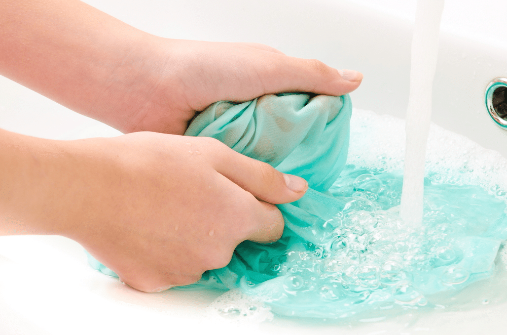 wasing clothes in water with hands washing clothes in water with hands