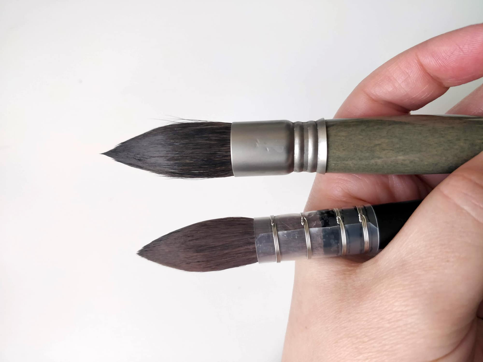 zoomed view of a hand holding - brushes zoomed view of a hand holding - brushes